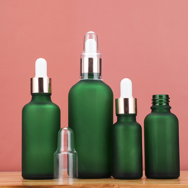 Custom Green Glass Dropper Bottles Lightproof Black Pipette Lids Essential Oil Facial Serum Empty Cosmetic Container