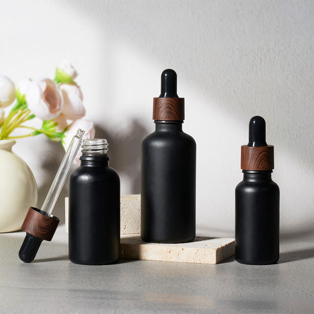 Custom Logo 10ml 20ml 30ml 50ml 100ml 1oz Matte Black Serum Essential Oil Glass Dropper Bottles With Dark Wood Grain Collar